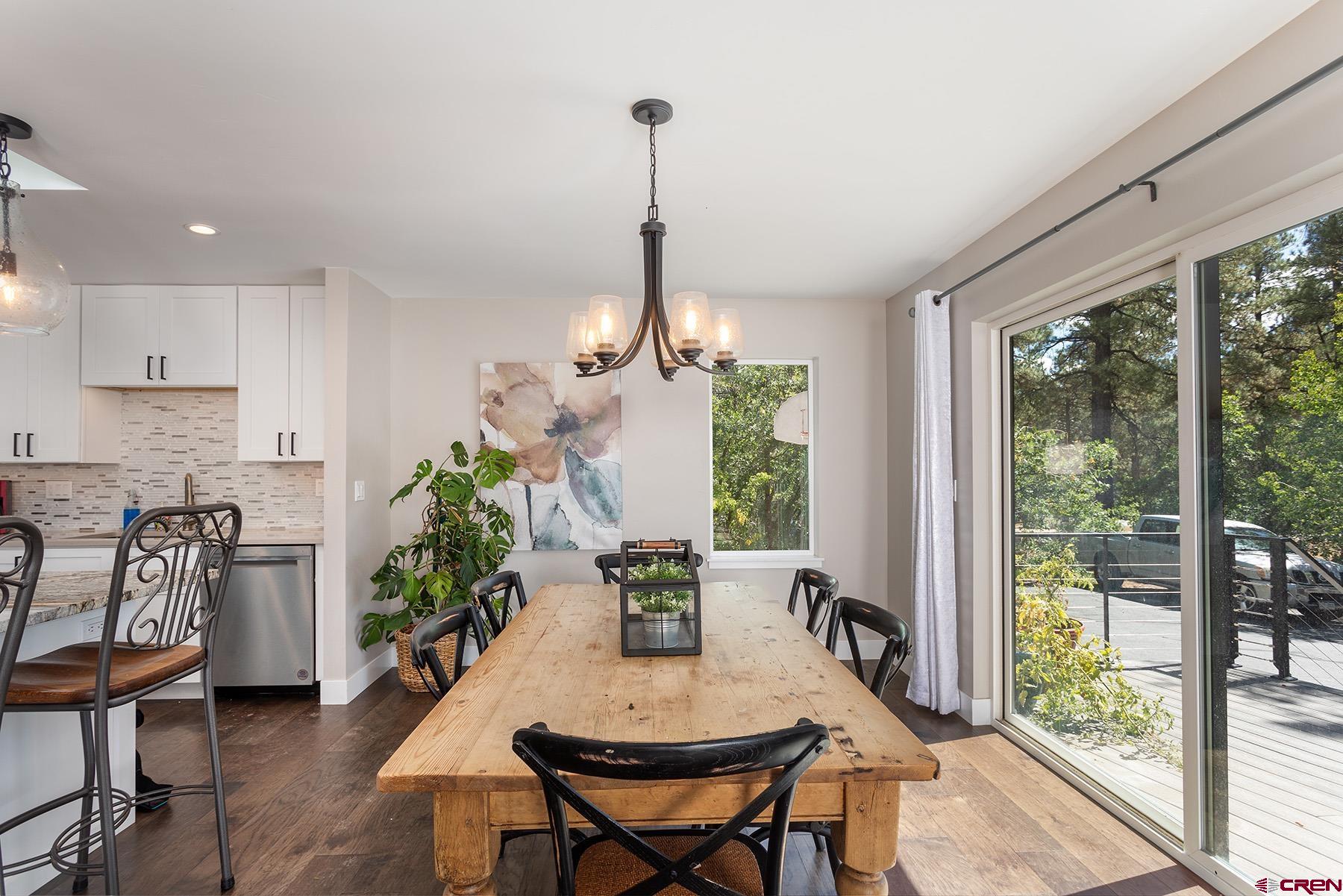 436 The Eagle Pass Durango, CO 81301 - Photo 12 of 29 a view of a dining room with furniture window and wooden floor