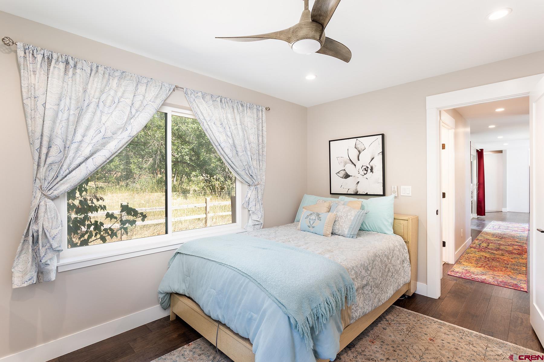 436 The Eagle Pass Durango, CO 81301 - Photo 18 of 29 a bedroom with a large bed and a large window