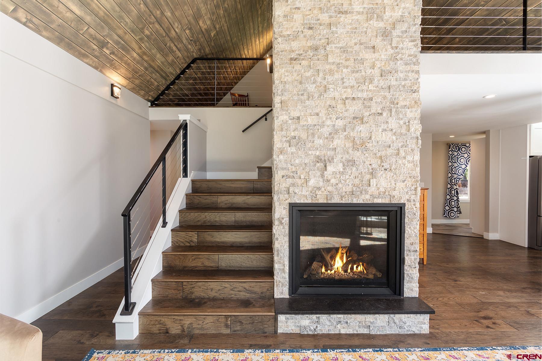 436 The Eagle Pass Durango, CO 81301 - Photo 5 of 29 a living room with a fireplace and a rug