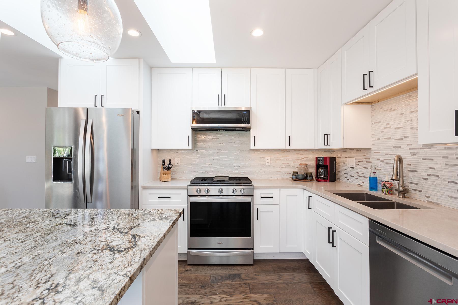 436 The Eagle Pass Durango, CO 81301 - Photo 9 of 29 a kitchen with stainless steel appliances granite countertop a stove a sink and a refrigerator