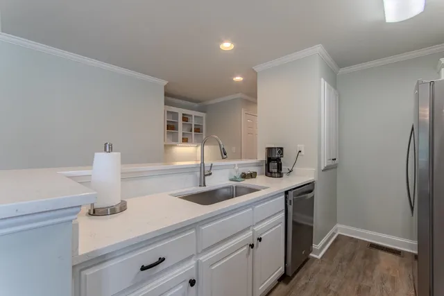 a kitchen with a sink and a refrigerator