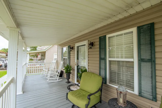 a view of a balcony with chairs and a table