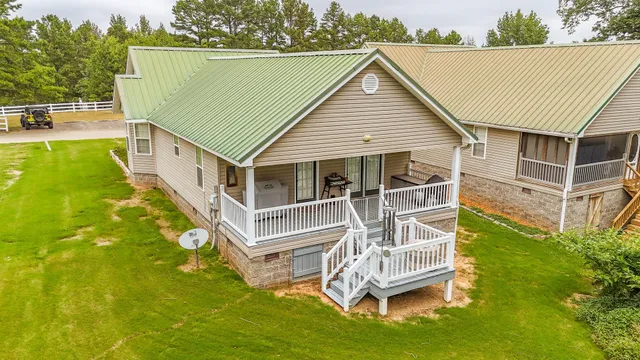a view of a house with pool and a yard