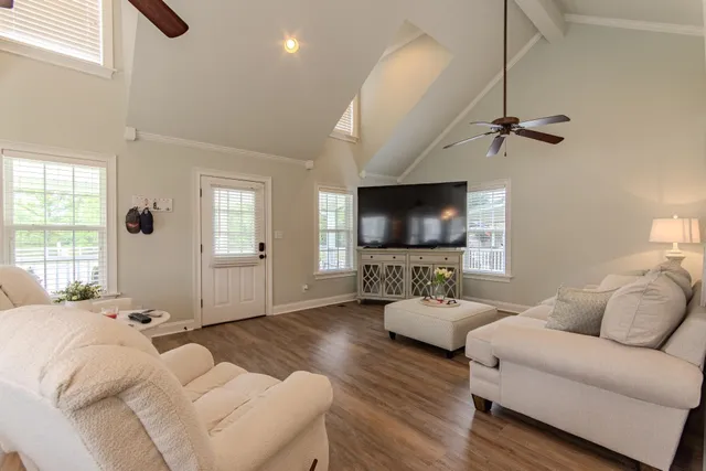 a living room with furniture ceiling fan and a window
