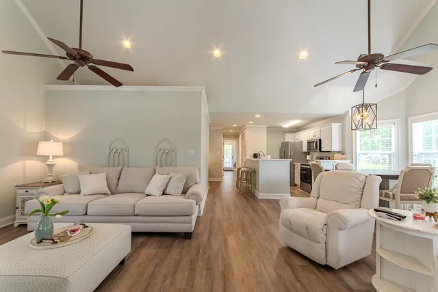 a living room with furniture and a wooden floor