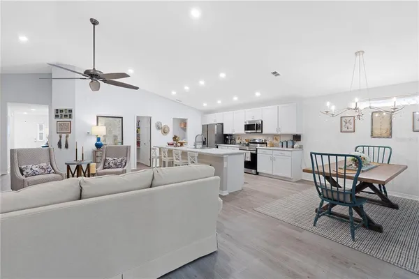 a kitchen with lots of clutter and cabinets
