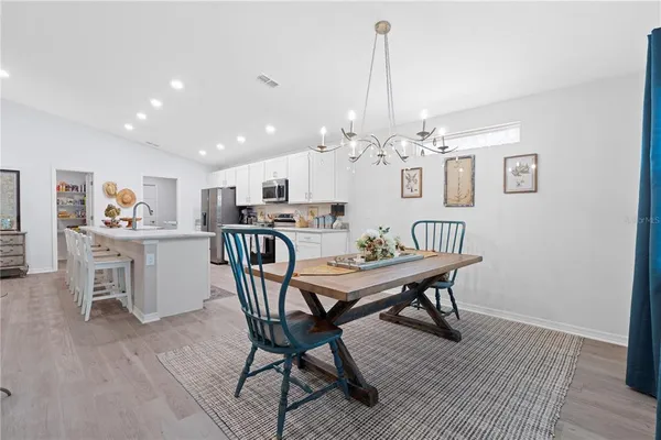 a living room with furniture kitchen view and a table