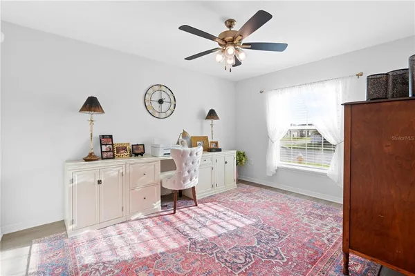 a workspace room with furniture and wooden floor
