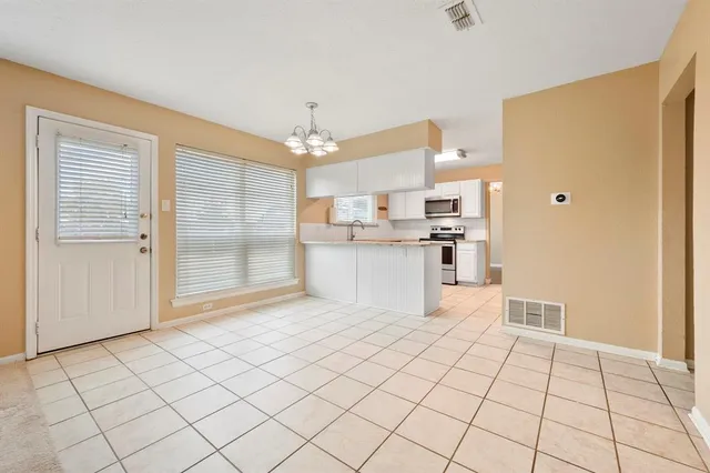 a kitchen with stainless steel appliances a refrigerator sink and cabinets