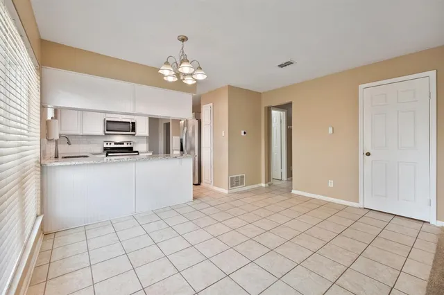 a view of a kitchen with microwave and cabinets