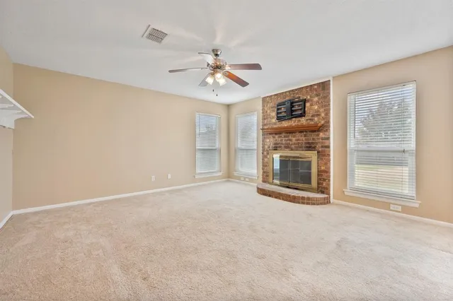 a view of a livingroom with a ceiling fan and window