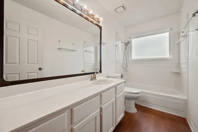 a bathroom with a sink a toilet and bathtub