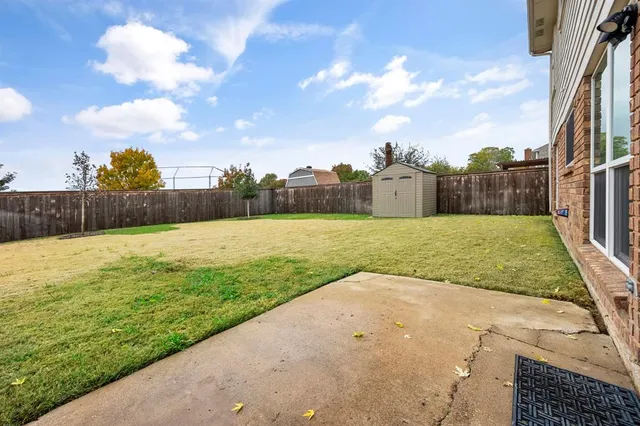 a view of a backyard with swimming pool