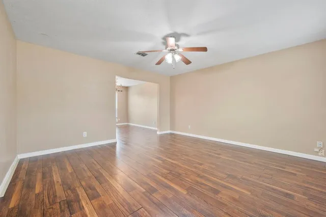 a view of an empty room and wooden floor