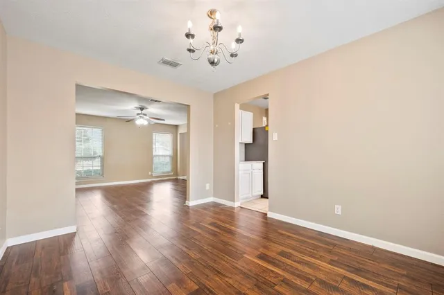 a view of a room with wooden floor