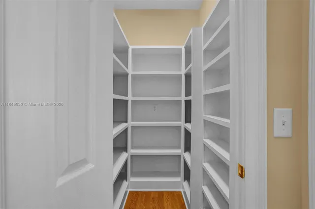 a view of walk in closet with empty racks