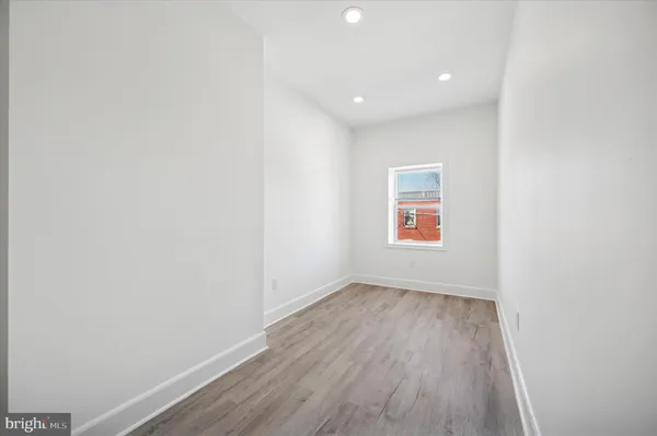 a view of room with wooden floor and window