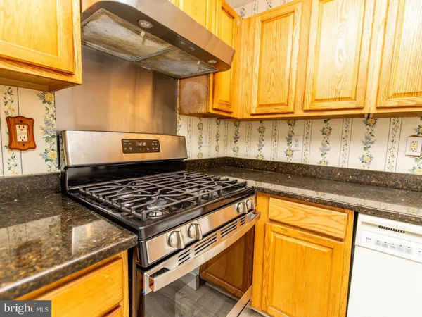 a stove top oven sitting inside of a kitchen