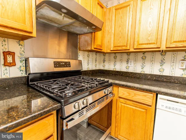 a stove top oven sitting inside of a kitchen