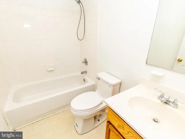a white toilet sitting next to a bath tub