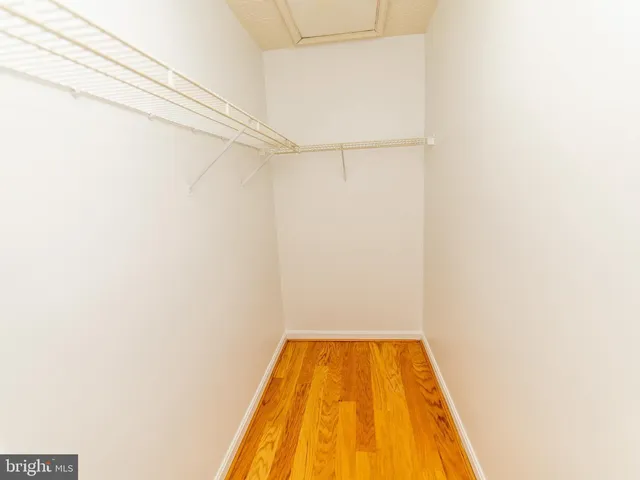 a small space with wooden floor and a window