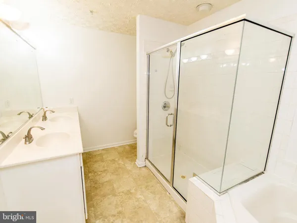 a bathroom with a shower and a sink