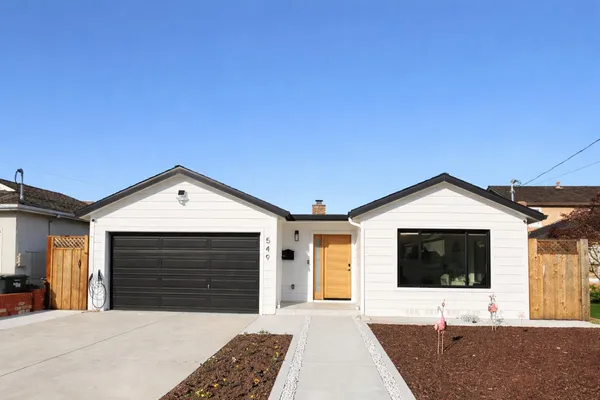 a front view of a house with a yard