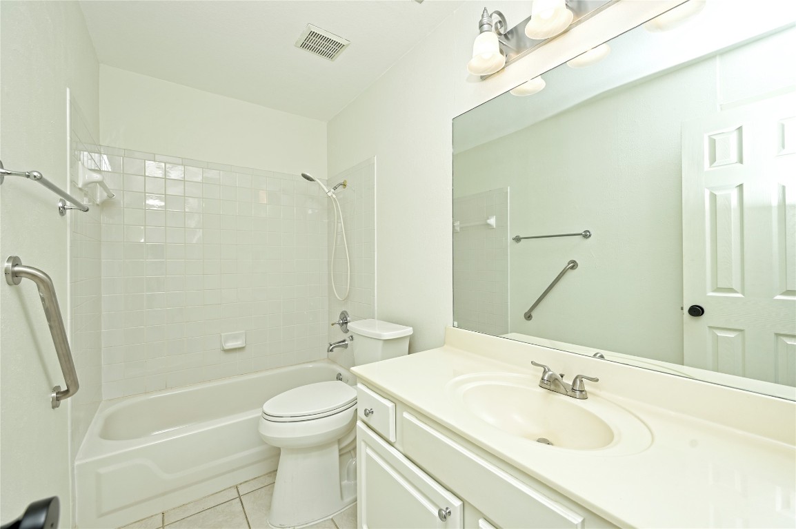 10917 Ballybunion Place Austin, TX 78747 - Photo 21 of 28 a bathroom with a sink a toilet and shower