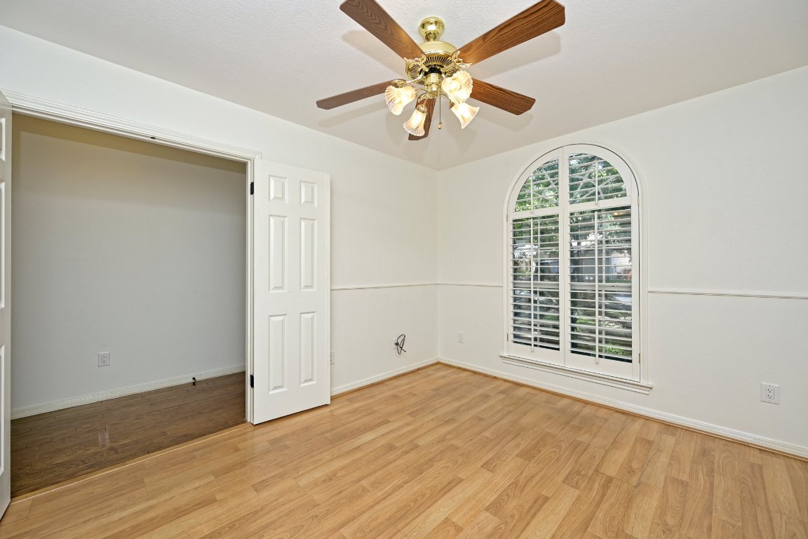 10917 Ballybunion Place Austin, TX 78747 - Photo 3 of 28 a view of empty room with wooden floor and fan