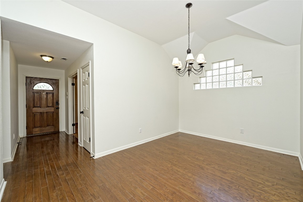 10917 Ballybunion Place Austin, TX 78747 - Photo 4 of 28 a view of a room with wooden floor chandelier and a window