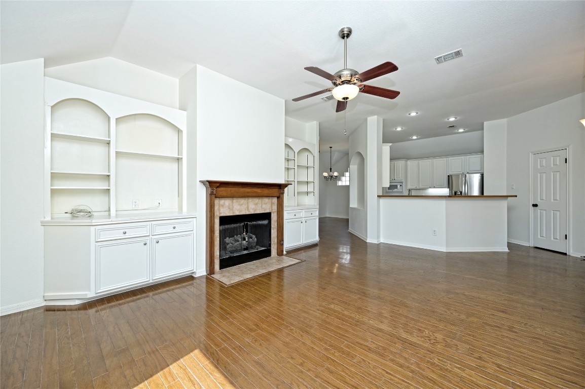 10917 Ballybunion Place Austin, TX 78747 - Photo 7 of 28 a view of a kitchen with furniture a ceiling fan and wooden floor