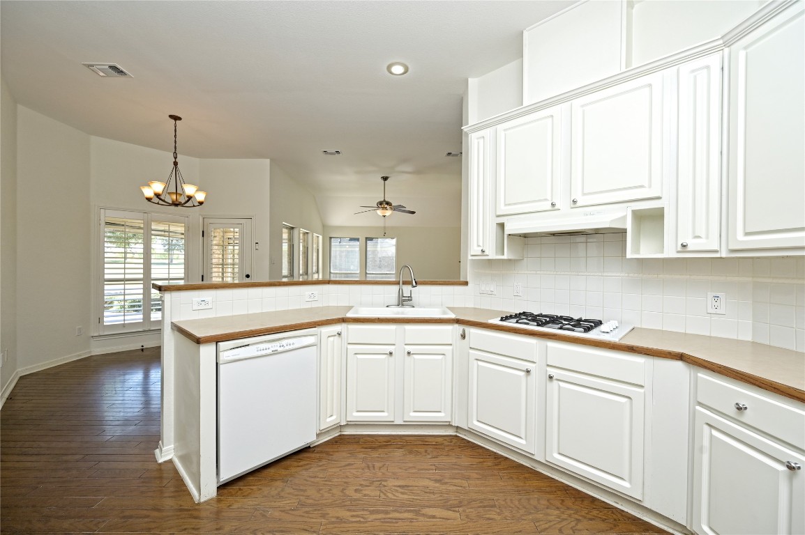 10917 Ballybunion Place Austin, TX 78747 - Photo 8 of 28 a kitchen with stainless steel appliances granite countertop a sink a stove and cabinets
