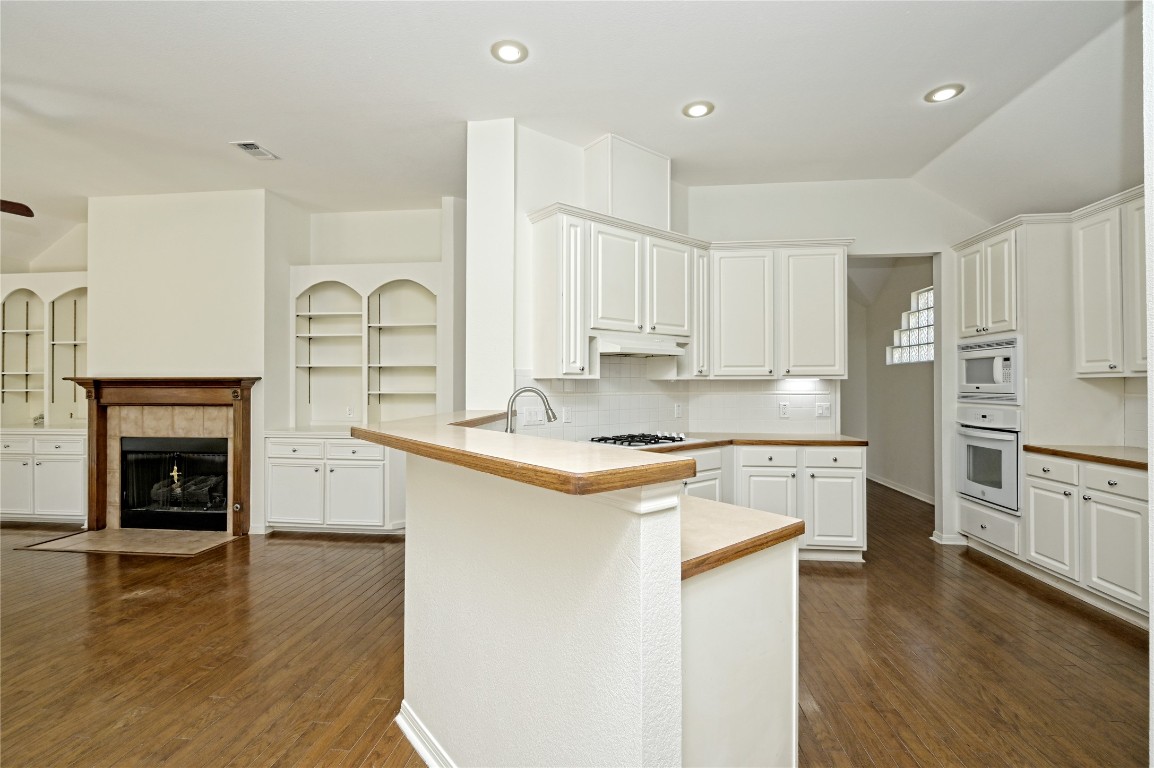 10917 Ballybunion Place Austin, TX 78747 - Photo 10 of 28 a kitchen with stainless steel appliances granite countertop a stove and a refrigerator