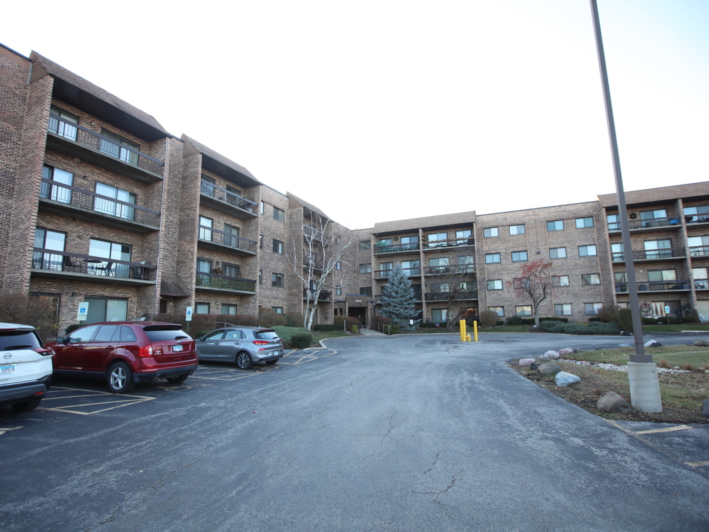 1400 North Elmhurst Road, Unit 417 Mount Prospect, IL 60056 - Photo 1 of 15 a cars parked in front of a building