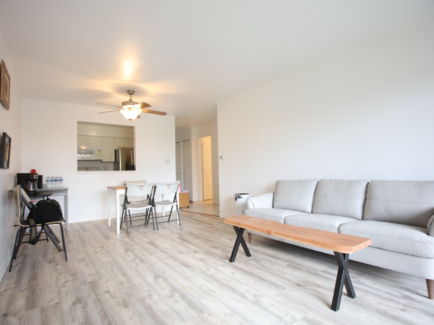 1400 North Elmhurst Road, Unit 417 Mount Prospect, IL 60056 - Photo 3 of 15 a living room with furniture and a dining table with wooden floor