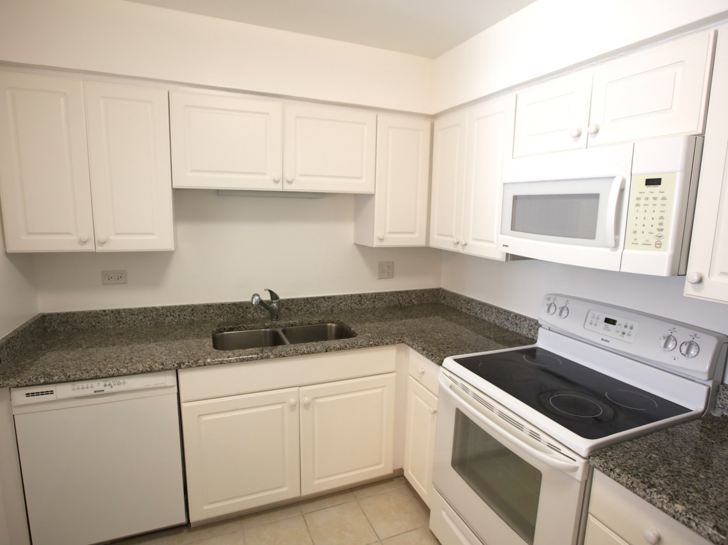 1400 North Elmhurst Road, Unit 417 Mount Prospect, IL 60056 - Photo 9 of 15 a kitchen with granite countertop white cabinets and white appliances