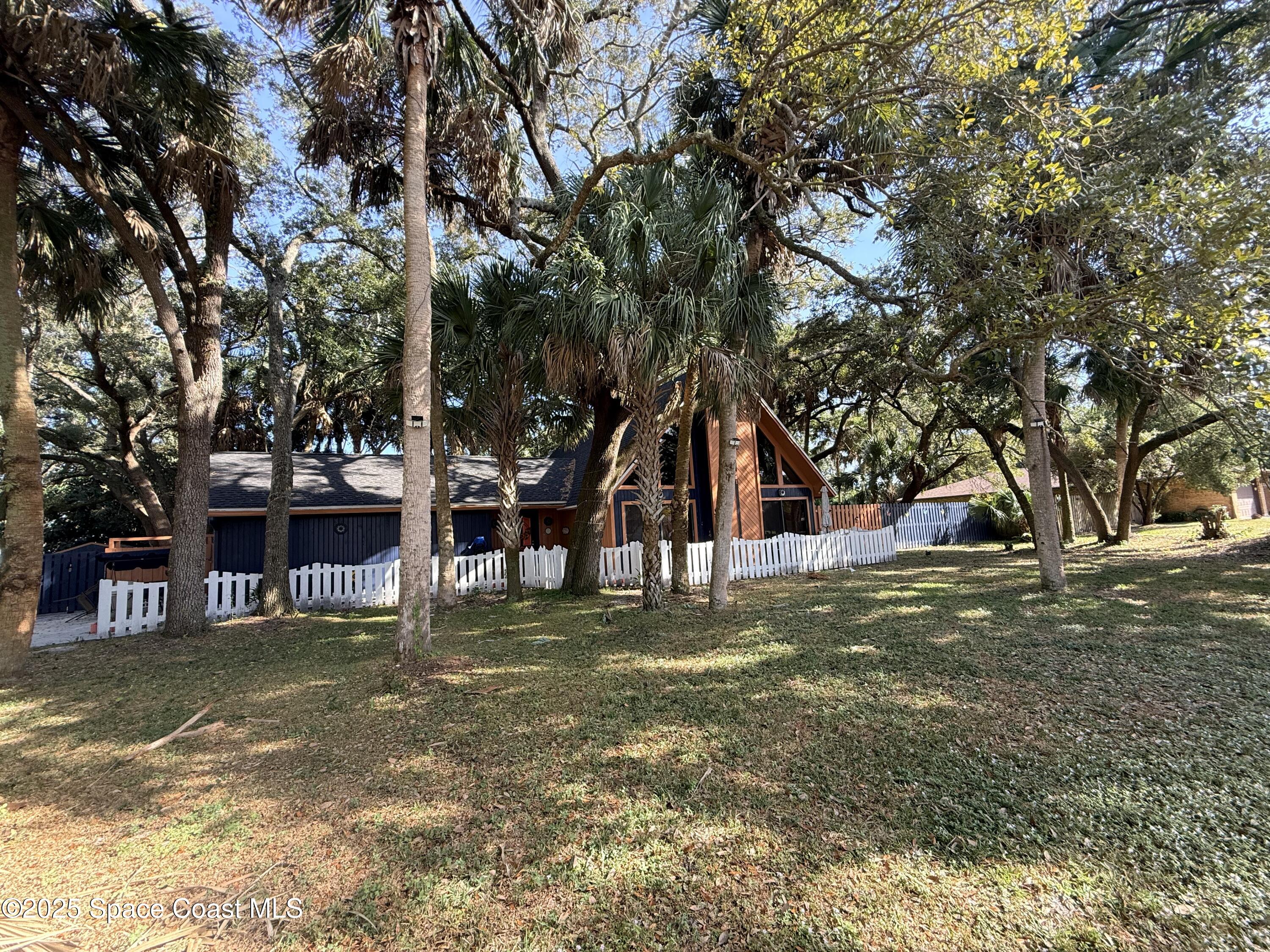 951 Pembroke Avenue Northeast Palm Bay, FL 32907 - Photo 2 of 10 a view of a house with a large tree
