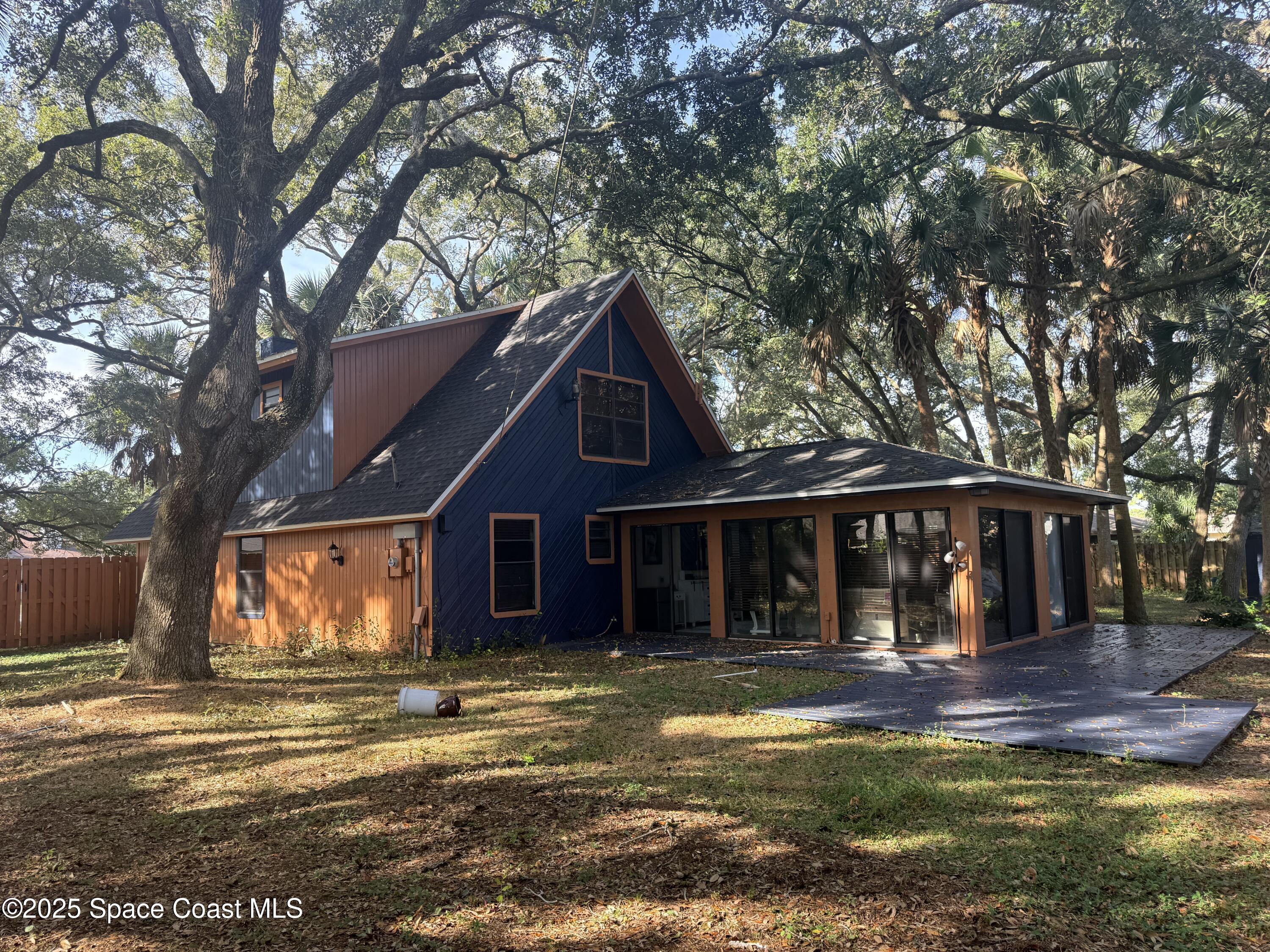 951 Pembroke Avenue Northeast Palm Bay, FL 32907 - Photo 7 of 10 a view of a house with garden and trees in the background