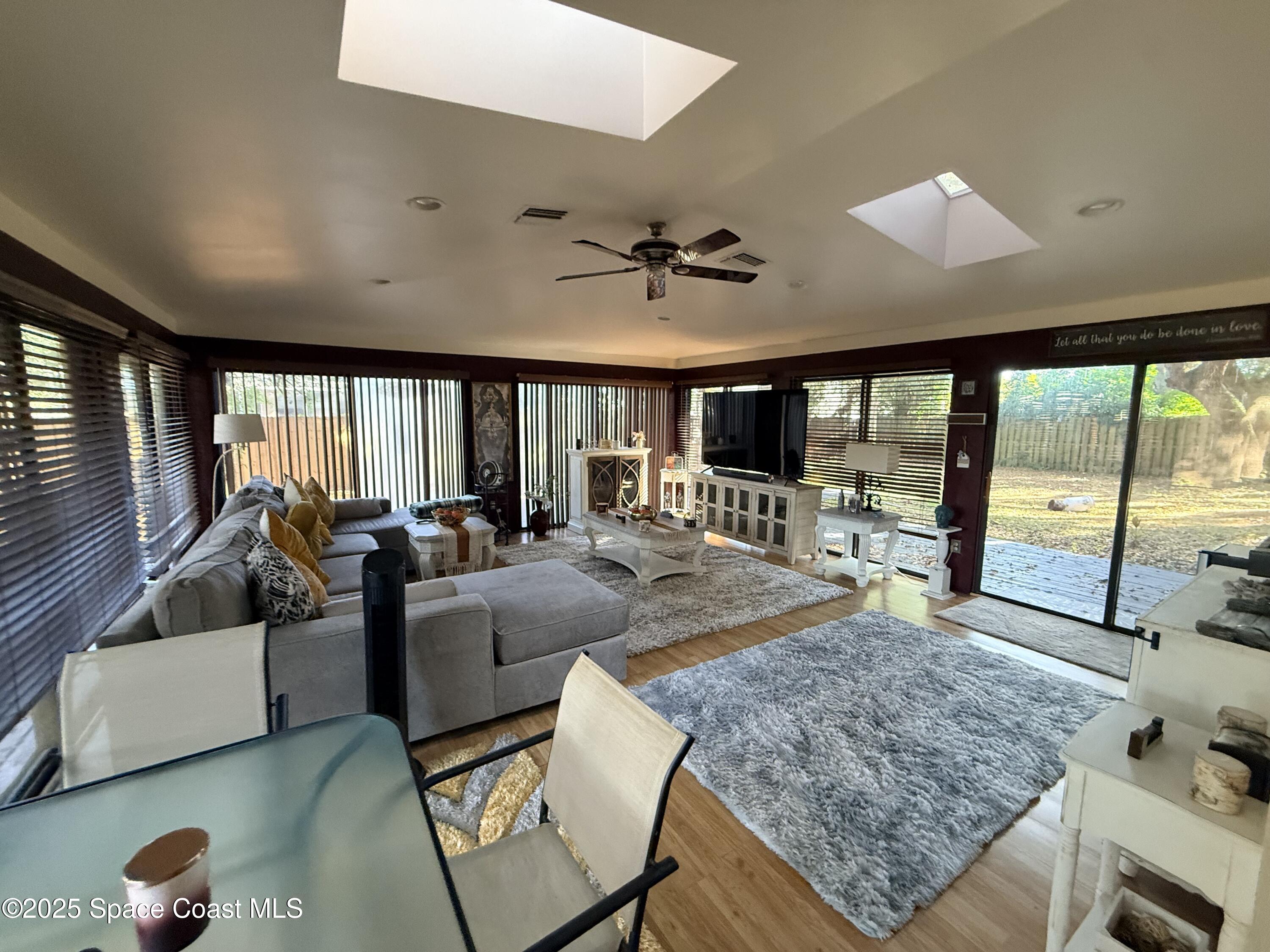 951 Pembroke Avenue Northeast Palm Bay, FL 32907 - Photo 10 of 10 a living room with furniture and a flat screen tv
