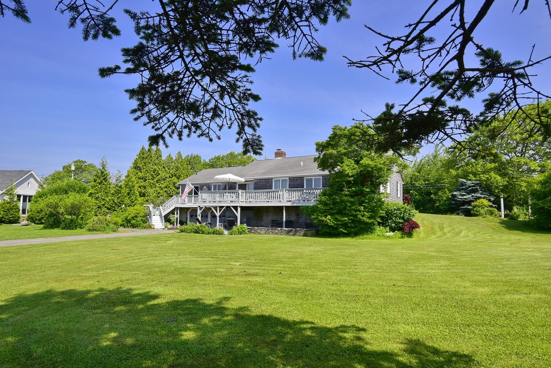 South facing view of deck and garage entry