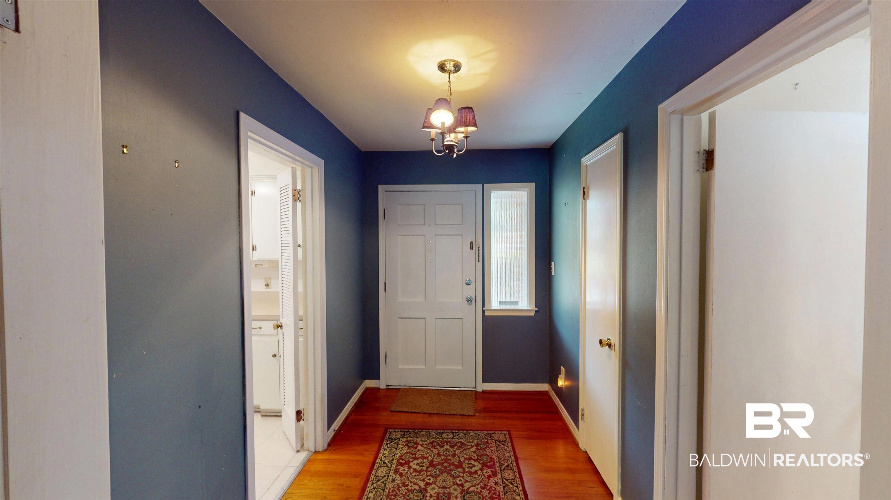 1075 Zurich Street Mobile, AL 36608 - Photo 11 of 35 Entrance foyer with light wood-style flooring and a chandelier