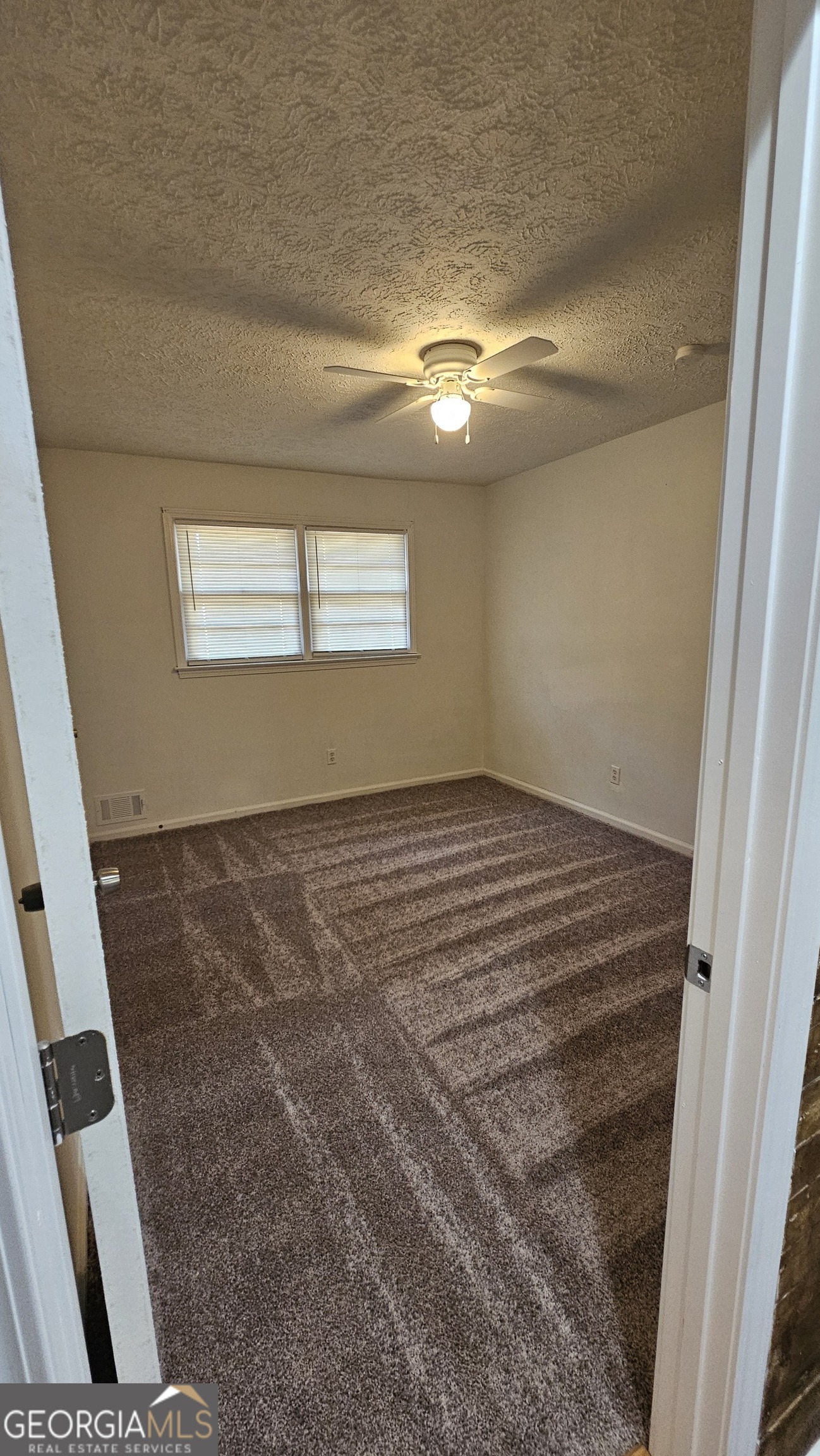 10167 Waterford Road Northeast Covington, GA 30014 - Photo 7 of 9 a view of empty room with window