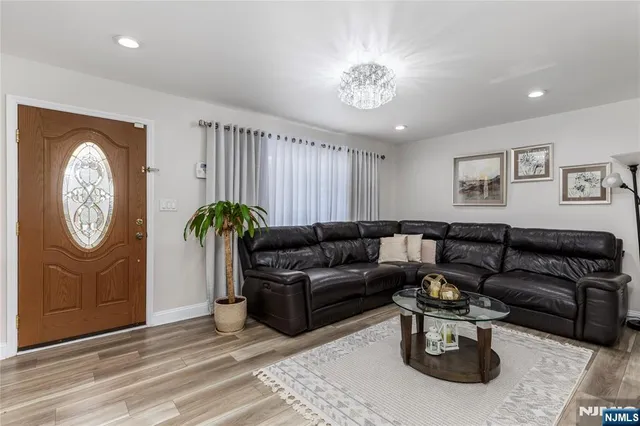 a living room with furniture a clock and a window