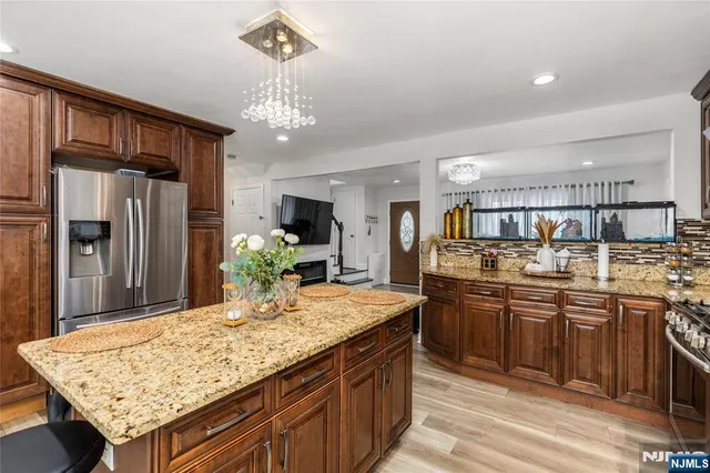 a kitchen with stainless steel appliances granite countertop granite counter tops refrigerator and cabinets