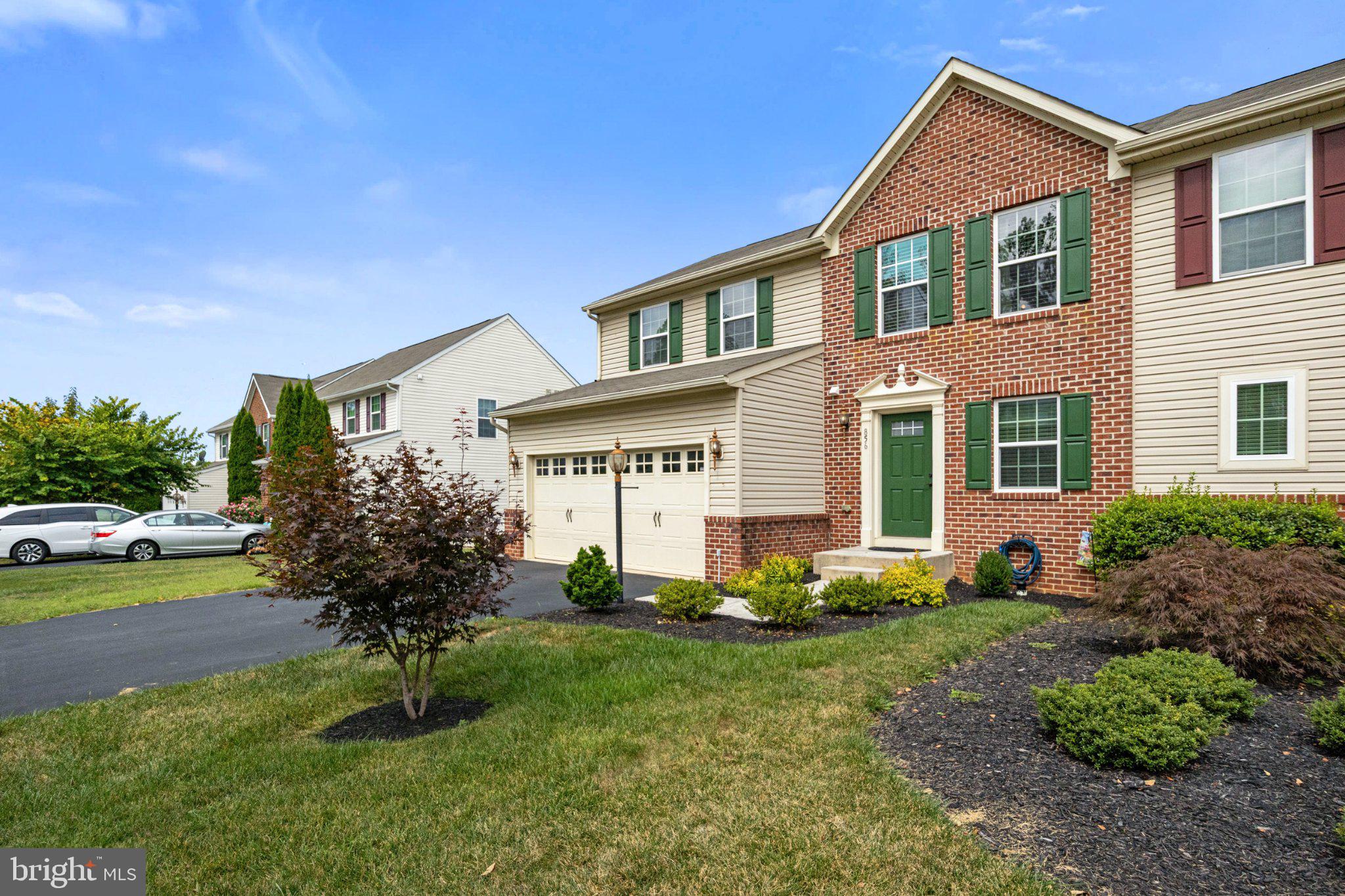 856 Countryside Road Seven Valleys, PA 17360 - Photo 2 of 47 Charming brick-front home with lush greenery.