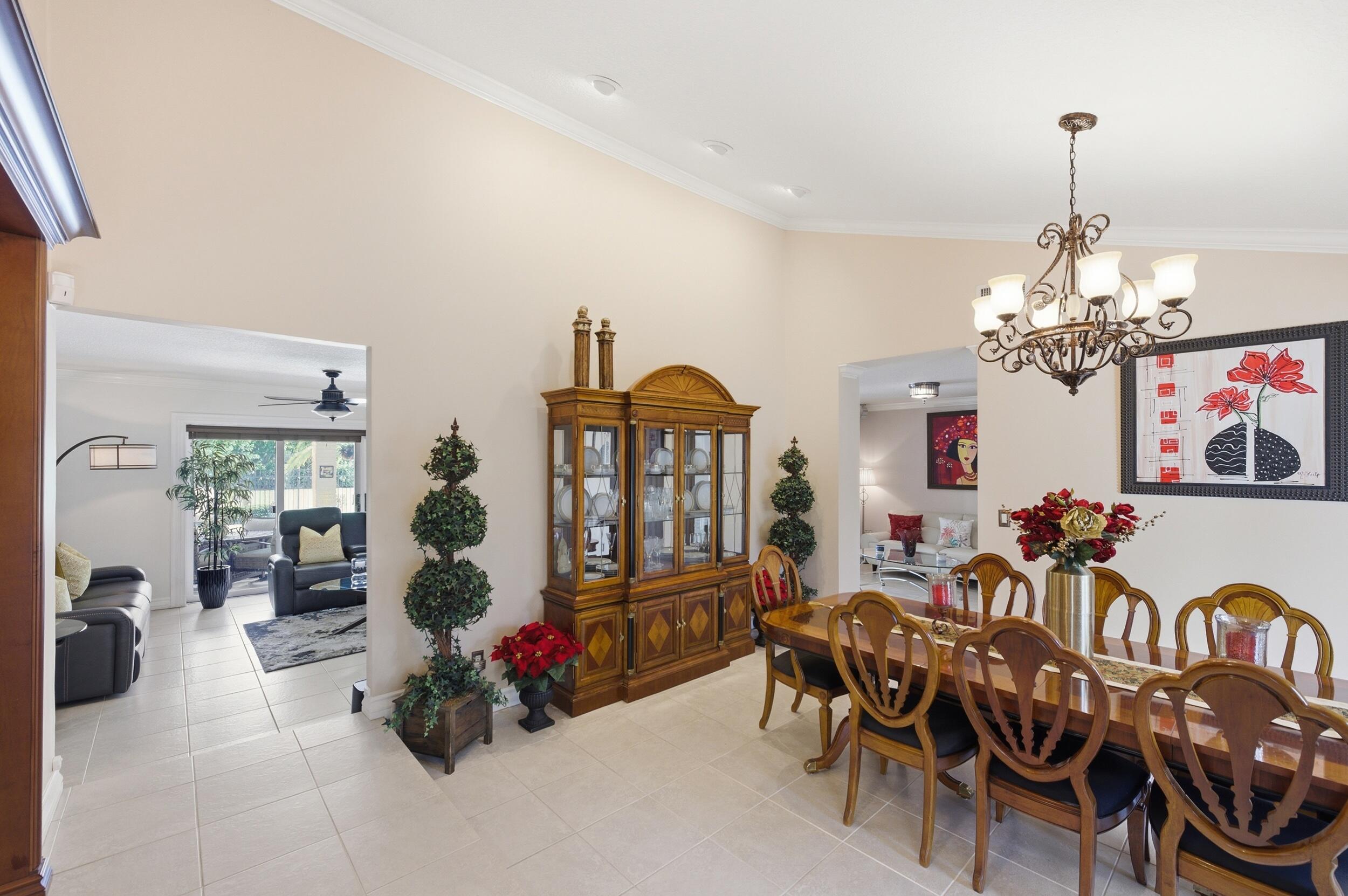 4780 Brandywine Drive Boca Raton, FL 33487 - Photo 9 of 43 a living room with furniture and a chandelier