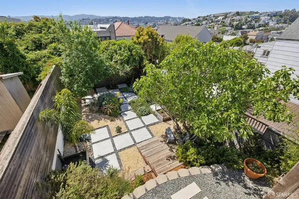 an aerial view of a house with a yard