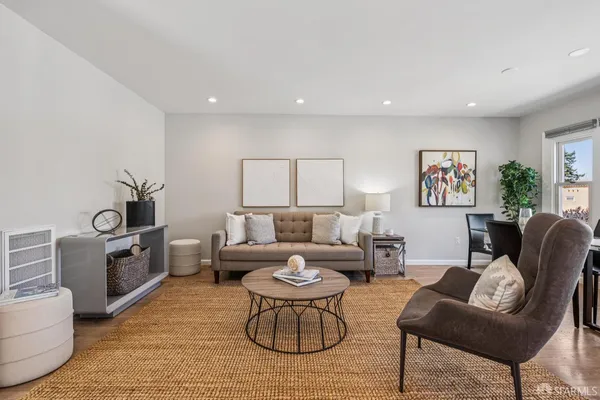 a living room with furniture and a potted plant
