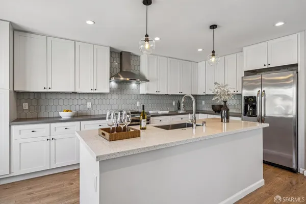 a kitchen with stainless steel appliances a sink stove and cabinets
