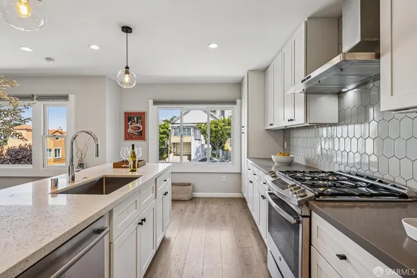a stove top oven sitting inside of a kitchen
